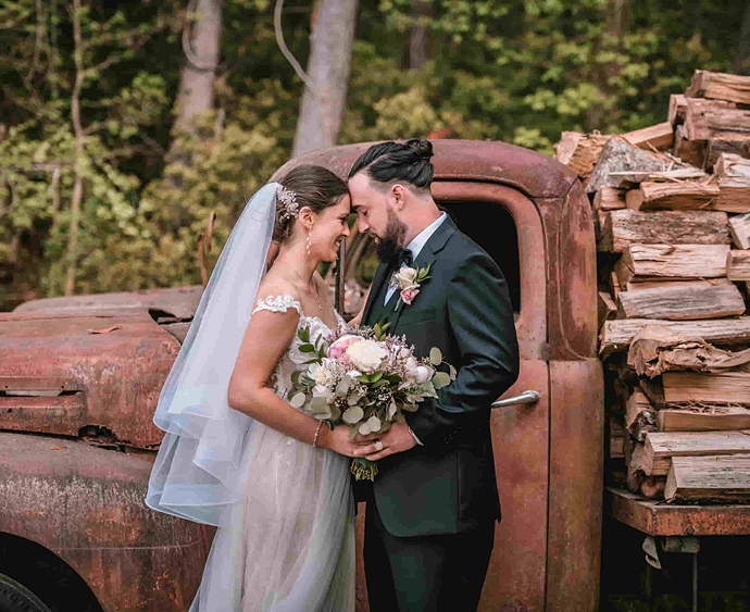 Orthodontist Dr. Joy Gerasco in her wedding dress, posing with her husband