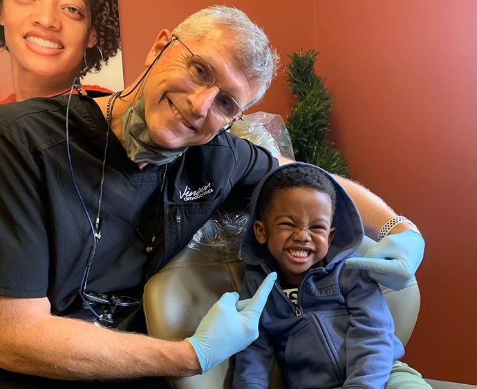 Dr Vinson with young smiling patient