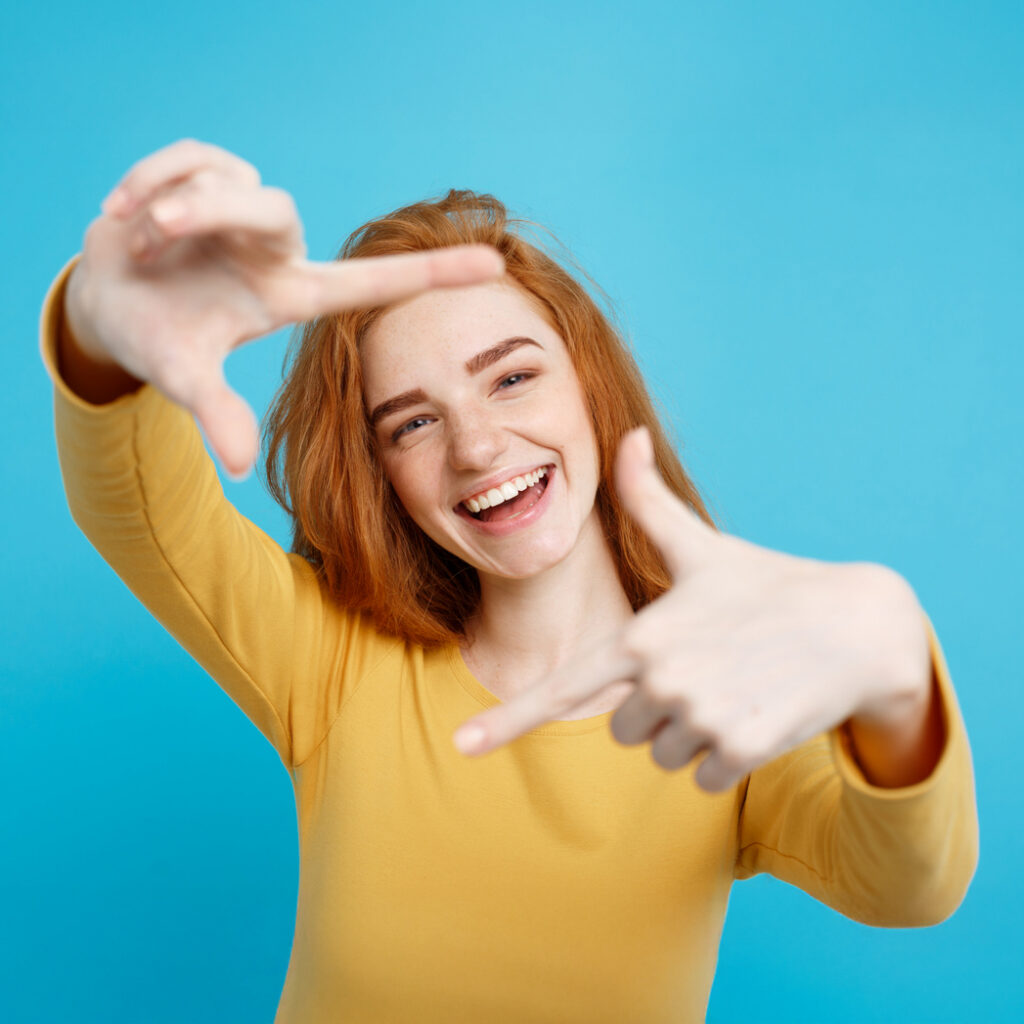 Happy Young Woman Making Box Shape With Her Hands