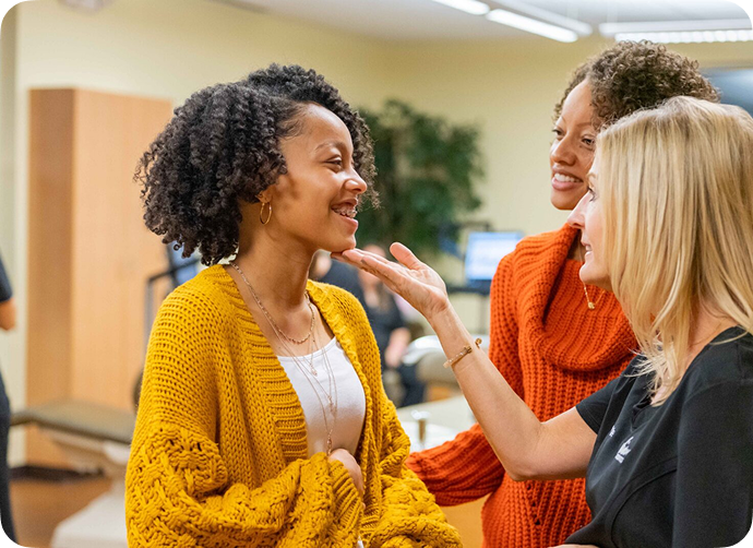 Smiling Joy Of Orthodontics Patient With Mother And Staff Member