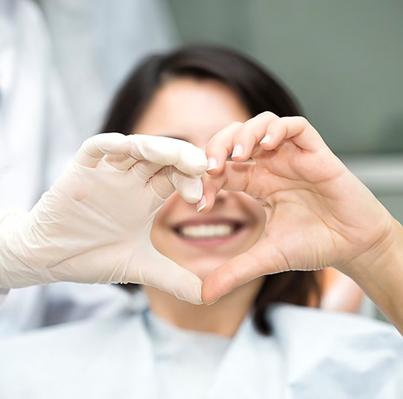 Female Patient And Orthodontist Making Heart Shape With Hands
